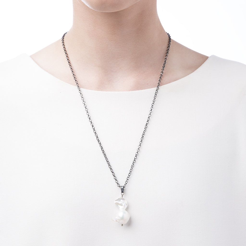 image of Slant Fine Jewelry's pearl pendant necklace worn by a woman