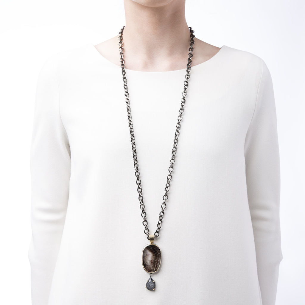 Image of Slant Fine Jewelry's natural druzy and super seven stone necklace being worn by a woman