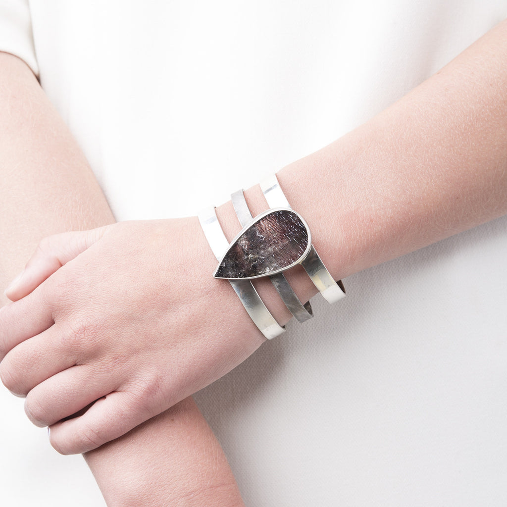 Photo of Slant Fine Jewelry's super seven cuff bracelet around a woman's wrist